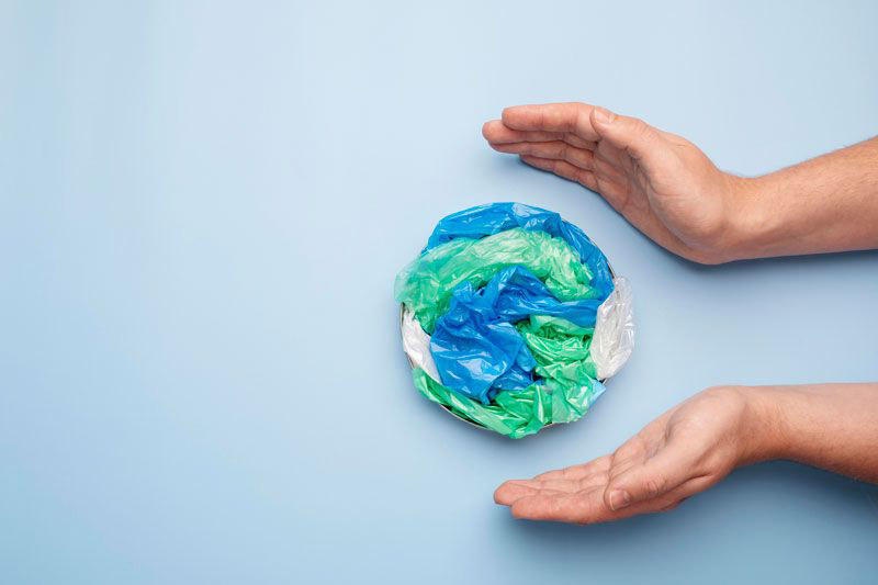 close up hand with plastic earth 9c36a7ee copy